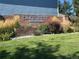 Community entrance sign reading 'Lakecrest Covenant Protected' surrounded by lush landscaping and a manicured lawn at 10440 W 83Rd Ave, Arvada, CO 80005