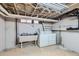 Basement laundry area with a utility sink and a white washing machine and dryer at 2541 Bellaire St, Denver, CO 80207