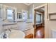 Bathroom featuring built-in cabinetry, hardwood floors, and ample storage at 2541 Bellaire St, Denver, CO 80207