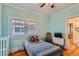 Bright bedroom features wood floors, two windows, and a ceiling fan at 2541 Bellaire St, Denver, CO 80207