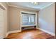 Bedroom with hardwood floors, large window seat with open windows and a radiator at 2541 Bellaire St, Denver, CO 80207
