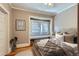 Inviting bedroom features a window seat, hardwood floors, and neutral decor at 2541 Bellaire St, Denver, CO 80207