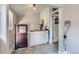 Entryway features hexagon tile, built-in cabinets, and access to the lower level at 2541 Bellaire St, Denver, CO 80207
