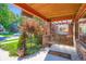 Inviting covered front porch with a swing, brick columns, and a cozy welcome mat at 2541 Bellaire St, Denver, CO 80207