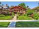 Charming brick home with beautiful landscaping, green lawn, and inviting curb appeal at 2541 Bellaire St, Denver, CO 80207