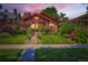 Charming brick home with beautiful landscaping, green lawn, and inviting curb appeal at 2541 Bellaire St, Denver, CO 80207