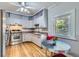 Bright eat-in kitchen with stainless steel appliances, gray cabinets, and retro-style dining set at 2541 Bellaire St, Denver, CO 80207