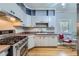 Cozy kitchen with stainless steel appliances, updated cabinets, and ample counter space at 2541 Bellaire St, Denver, CO 80207