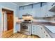 Updated kitchen featuring stainless steel range, ample counter space, and classic cabinetry at 2541 Bellaire St, Denver, CO 80207