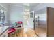 Efficient kitchen layout with stainless steel fridge, retro chairs and a pass through door at 2541 Bellaire St, Denver, CO 80207