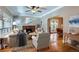 Sunlit living room with hardwood floors, fireplace, and open layout to dining area at 2541 Bellaire St, Denver, CO 80207