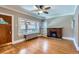 Bright living room featuring hardwood floors, brick fireplace, and large windows at 2541 Bellaire St, Denver, CO 80207