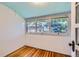 Bright sunroom with beadboard walls, hardwood floors, and large windows overlooking the backyard at 2541 Bellaire St, Denver, CO 80207