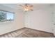 The bedroom features neutral carpet, a ceiling fan, and a window at 7904 Chase Cir # 147, Arvada, CO 80003