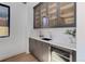Elegant butler's pantry with a sleek countertop, sink, wine fridge, and glass-front cabinets at 352 S High St, Denver, CO 80209