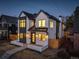 Stunning two-story home featuring elegant white brick, striking black trim, and warm, inviting exterior lighting at 352 S High St, Denver, CO 80209