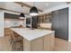 Spacious kitchen with an island, breakfast bar, pendant lighting, and wood beams at 352 S High St, Denver, CO 80209