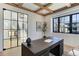 Stylish office featuring a coffered ceiling, hardwood floors, a large window, and a glass paneled door at 352 S High St, Denver, CO 80209