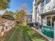 Landscaped backyard featuring a rock wall, trees, patio seating area and a hot tub at 140 Sugar Plum Way, Castle Rock, CO 80104