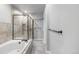 A soaking tub sits adjacent to a glass enclosed shower with tile surround and multiple towel bars at 140 Sugar Plum Way, Castle Rock, CO 80104