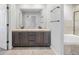 Bathroom with a double sink vanity, large mirror and combined tub and shower at 140 Sugar Plum Way, Castle Rock, CO 80104