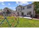 Spacious backyard featuring a patio, lush lawn, and play structure at 16581 Buckthorn Ln, Parker, CO 80134