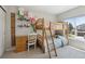 Bright bedroom featuring custom decor, a desk area, and a bunk bed, perfect for children or guests at 16581 Buckthorn Ln, Parker, CO 80134