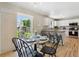 Bright dining area with backyard view, marble table, and seamless access to the kitchen's breakfast bar at 16581 Buckthorn Ln, Parker, CO 80134