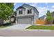 Charming two-story home with a gray exterior, well-maintained lawn, and attached two-car garage at 16581 Buckthorn Ln, Parker, CO 80134