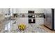 Bright kitchen featuring granite counters, white cabinets and stainless steel appliances at 16581 Buckthorn Ln, Parker, CO 80134