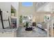 Bright living room with a stone fireplace, large windows, and comfortable seating at 16581 Buckthorn Ln, Parker, CO 80134