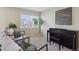 Comfortable living room featuring lots of natural light and a modern piano at 16581 Buckthorn Ln, Parker, CO 80134