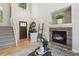 Open living space with hardwood floors, stone fireplace, and staircase at 16581 Buckthorn Ln, Parker, CO 80134