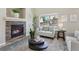 Warm living room with stone fireplace, comfortable seating, and natural light at 16581 Buckthorn Ln, Parker, CO 80134