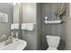 Stylish powder room features elegant gray walls, modern fixtures, and a decorative shelf at 16581 Buckthorn Ln, Parker, CO 80134
