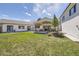 Large backyard with lush lawn and a covered patio dining area at 6102 S Aberdeen St, Littleton, CO 80120