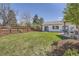 Sprawling backyard featuring a well-maintained lawn and landscaping at 6102 S Aberdeen St, Littleton, CO 80120