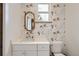 Bathroom boasts tiger-themed wallpaper, a modern vanity, and an oval mirror at 6102 S Aberdeen St, Littleton, CO 80120