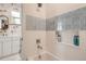Beautiful bathroom features a tiled shower with a built-in storage niche and tiger-themed wallpaper at 6102 S Aberdeen St, Littleton, CO 80120