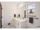 Bright bathroom featuring a double vanity, large mirror, and natural light at 6102 S Aberdeen St, Littleton, CO 80120