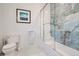 Modern bathroom featuring tiled walls, sleek fixtures, and a glass-enclosed shower/tub combination at 6102 S Aberdeen St, Littleton, CO 80120