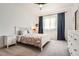 Cozy bedroom features carpet, bright light from the window, and a ceiling fan at 6102 S Aberdeen St, Littleton, CO 80120