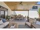 Outdoor patio area with a dining set, lounge furniture, and a built-in kitchen at 6102 S Aberdeen St, Littleton, CO 80120
