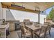 Outdoor kitchen and dining area on a covered patio, complete with grill and sink at 6102 S Aberdeen St, Littleton, CO 80120