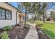 Charming home exterior with lush landscaping, stone pathway and outdoor seating area at 6102 S Aberdeen St, Littleton, CO 80120