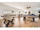 Spacious game room with hardwood floors, pool table, foosball table, and other various games at 6102 S Aberdeen St, Littleton, CO 80120