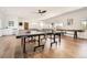 Alternate view of game room with ping pong table and light hardwood flooring at 6102 S Aberdeen St, Littleton, CO 80120