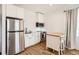 Kitchen featuring stainless steel appliances, white cabinets, and wood floors at 6102 S Aberdeen St, Littleton, CO 80120