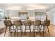 Contemporary kitchen with modern appliances, custom cabinets, and island seating for five at 6102 S Aberdeen St, Littleton, CO 80120