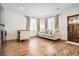 Cozy living room with hardwood floors, sofa, and natural light from the windows at 6102 S Aberdeen St, Littleton, CO 80120